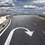 Curved road with a U-turn arrow marking.