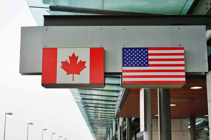 1044483421 featured image Canadian and American flags on a building structure