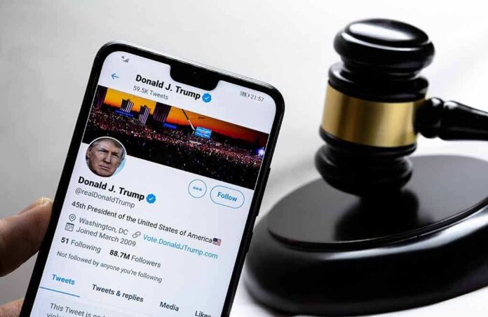 1889360596 featured image Smartphone displaying Twitter profile beside a judge’s gavel.