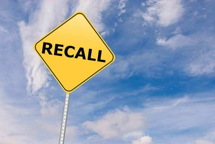529192612 featured image Yellow recall sign against blue cloudy sky