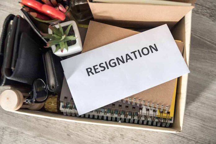 1487893499 featured image Envelope labeled RESIGNATION atop office supplies in box