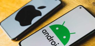 Android and Apple smartphones on a wooden table