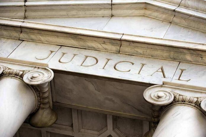 Marble columns with the word Judicial engraved above