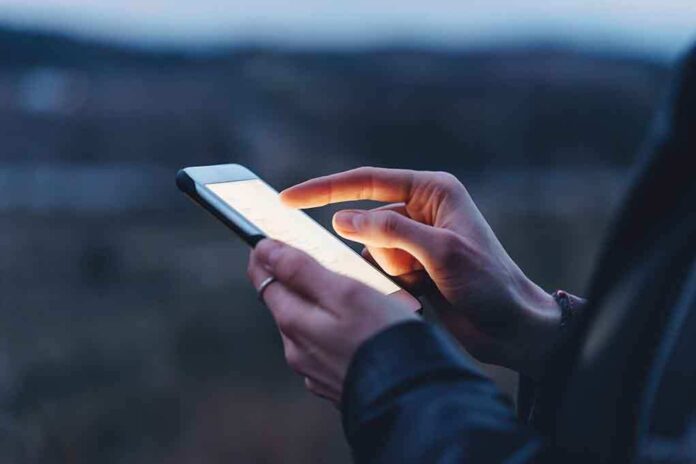 585973055 featured image Person using a smartphone at dusk