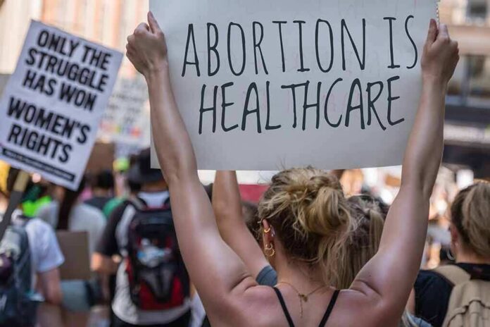 Protestors holding signs about women's rights and healthcare