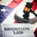 Book titled Abortion Law gavel American flag background