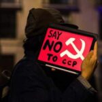 Person holding sign saying "Say No to CCP"
