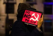 Person holding sign saying "Say No to CCP"