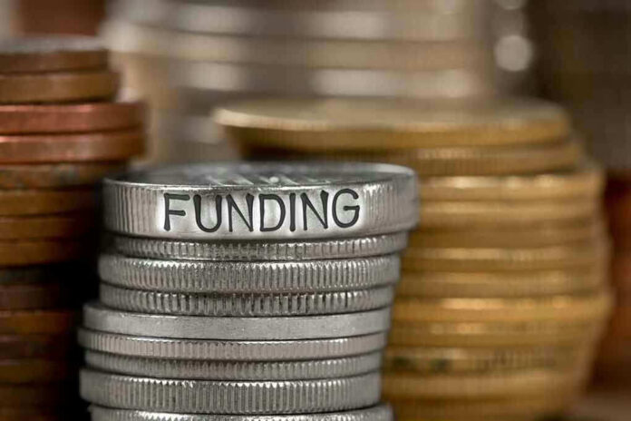 784896787 Stack of coins labeled funding with other coins stacks