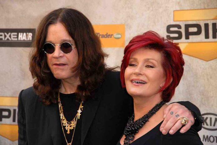 A celebrity couple posing together at a red carpet event, smiling and dressed in stylish outfits