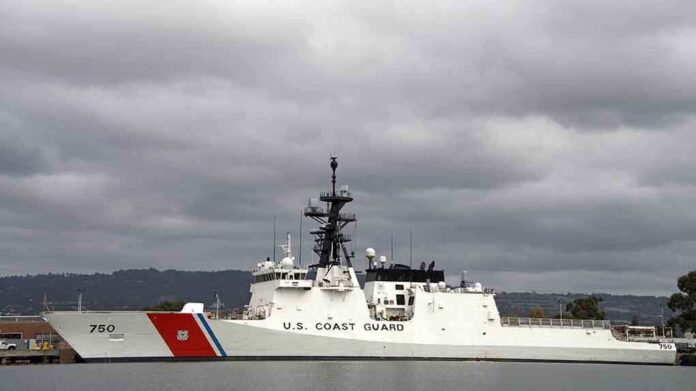 shutterstock_229880047.jpg A US Coast Guard ship docked under cloudy skies