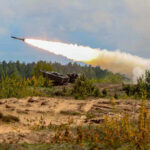 Military tank firing a missile in forest area.