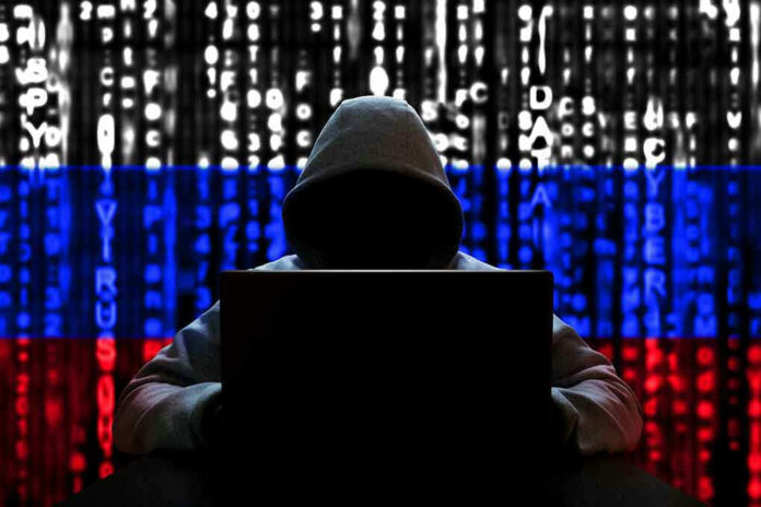 Hacker in hoodie with Russian flag background and code.
