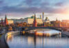 Kremlin by river at sunset with bridge