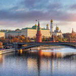 Kremlin by river at sunset with bridge