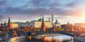 Kremlin by river at sunset with bridge