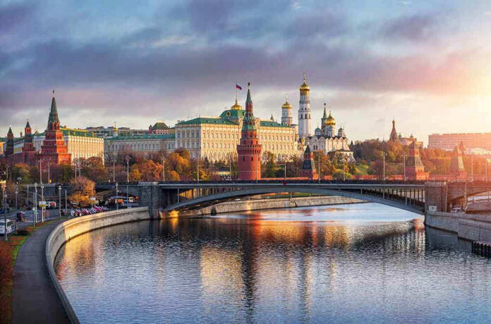 Kremlin by river at sunset with bridge