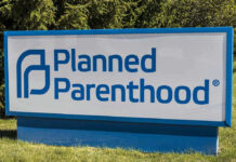 Planned Parenthood sign on a grassy lawn