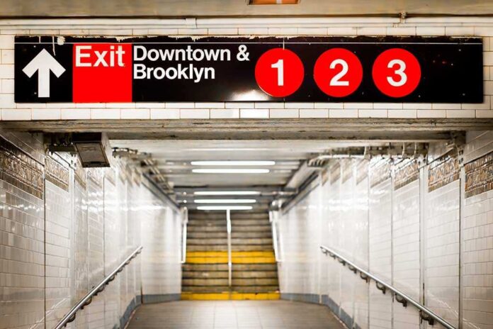 Subway exit sign indicating Downtown and Brooklyn with train numbers 1, 2, and 3