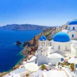 Scenic view of Santorini with blue domed buildings overlooking the Mediterranean Sea