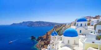Scenic view of Santorini with blue domed buildings overlooking the Mediterranean Sea