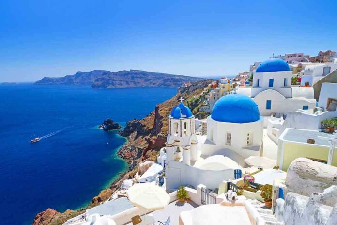 shutterstock_132953783.jpg Scenic view of Santorini with blue domed buildings overlooking the Mediterranean Sea