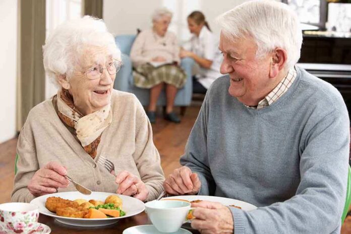 Elderly couple enjoying a meal together in a dining room