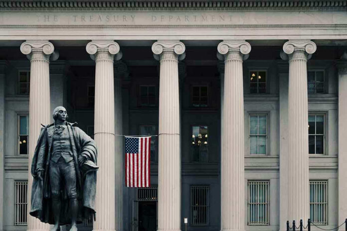 US Treasury Department building with statue and flag.