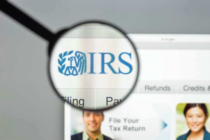 Magnifying glass over IRS website.