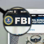 FBI website shown through magnifying glass.