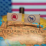 Republican and Democratic flags on USA map background.