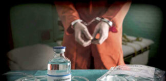 Vial labeled Sodium Thiopental near handcuffed person.