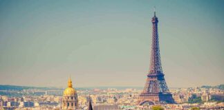 A panoramic view of Paris featuring the Eiffel Tower and a golden dome