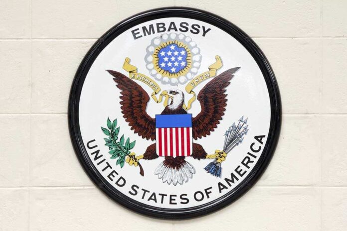 Seal of the United States Embassy featuring an eagle and the American flag