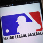 Federal Charges Rock MLB—Betting Scandal Unfolds Major League Baseball logo on a smartphone screen.