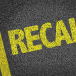 Engine DEBRIS Disaster—Recall Nightmare Returns! Yellow RECALL text on asphalt background.