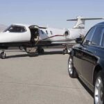 Far-Left Dems LAVISH Spending – She Paid How Much?! A private jet parked at an airport with a luxury car in the foreground