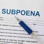 2 Dozen SUBPOENAS Filed – Grand Conspiracy Probe! A subpoena document with a blue pen resting on it