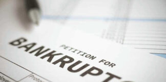 Petition for bankruptcy document with pen.