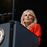 Person speaking at podium with Vice President seal.
