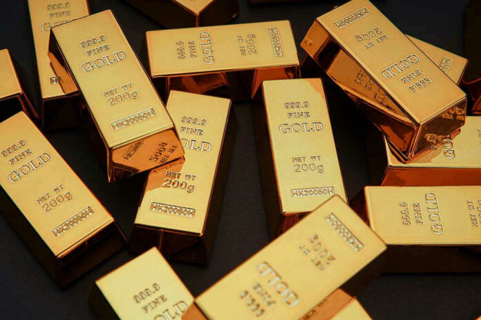Gold bars stacked on dark background