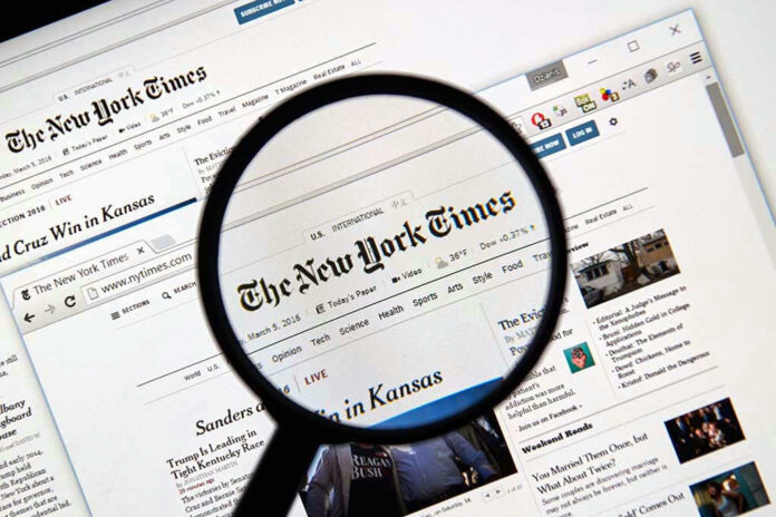 Magnifying glass over The New York Times website.