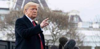 Donald Trump gesturing while speaking to the press outside