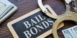 A bail bonds sign with handcuffs and stacks of cash