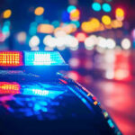 Police car with flashing lights at night.