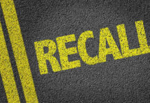 Yellow RECALL text on asphalt background.