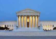 The U.S. Supreme Court building illuminated at night