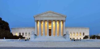 The U.S. Supreme Court building illuminated at night