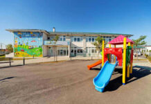 Colorful playground slide in front of a building.