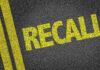 DOZENS Vehicles Already BURNED — Massive Recall! Yellow RECALL text on asphalt background.